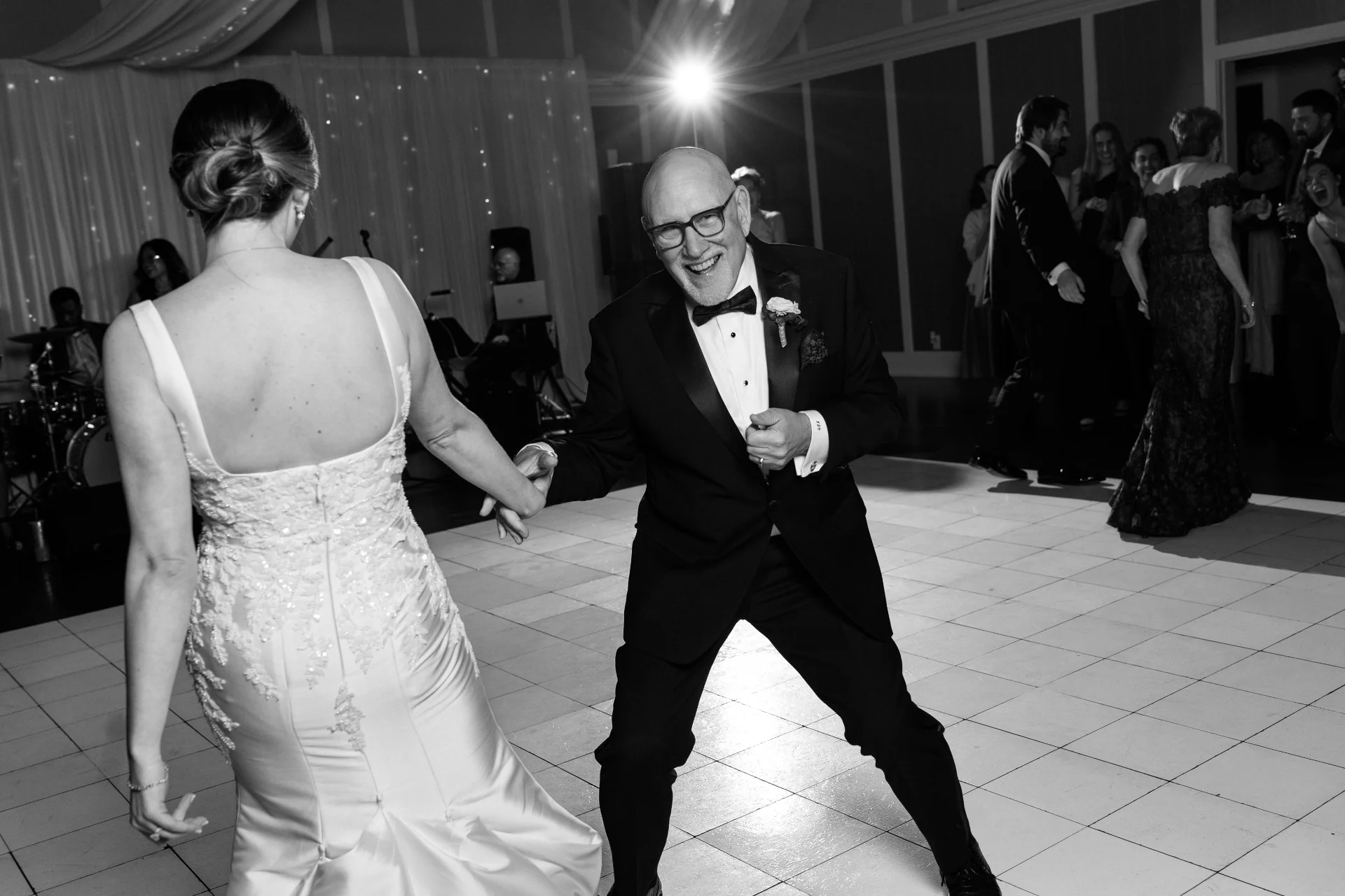 A man and woman at a wedding dancing. Phot by C.Mae Photography.