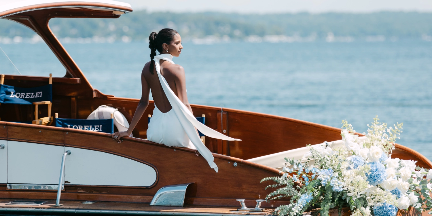 Newly wed woman on a boat with flowers. Photo shot by C.Mae Photography.