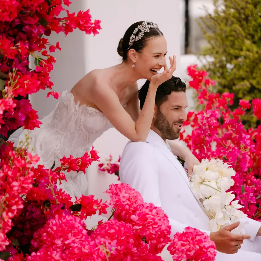A couple getting married and surrounded by beautiful flower. Photo by C.Mae Photography.